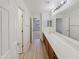 Bright bathroom with wood floors, a large vanity, and a large mirror at 19432 W Morning Glory Dr, Buckeye, AZ 85326