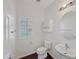 Charming half bath featuring a pedestal sink, round mirror, and natural lighting at 19432 W Morning Glory Dr, Buckeye, AZ 85326