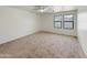 Bedroom featuring plush carpet, a ceiling fan, and two bright windows at 19432 W Morning Glory Dr, Buckeye, AZ 85326
