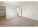 Neutral carpeted bedroom with ceiling fan and closet access at 19432 W Morning Glory Dr, Buckeye, AZ 85326