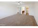 Large carpeted bedroom with access to a bathroom and closet at 19432 W Morning Glory Dr, Buckeye, AZ 85326