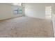 Expansive bonus room features plush carpeting, a ceiling fan, and ample natural light at 19432 W Morning Glory Dr, Buckeye, AZ 85326