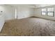 Large bonus room with neutral carpet, ceiling fan, two windows and ample space at 19432 W Morning Glory Dr, Buckeye, AZ 85326