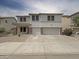 Charming two-story home boasts a three car garage, low maintenance landscaping and a welcoming front porch at 19432 W Morning Glory Dr, Buckeye, AZ 85326