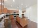 Spacious kitchen featuring an island, stainless steel appliances, granite counters, and wood floors at 19432 W Morning Glory Dr, Buckeye, AZ 85326