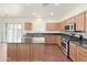 Well-lit kitchen with an island, stainless appliances, granite counters, and wood floors at 19432 W Morning Glory Dr, Buckeye, AZ 85326