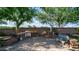 Brick-paved backyard featuring an outdoor kitchen, BBQ, stone waterfall, and comfortable seating area at 1970 E Yellowstone Pl, Chandler, AZ 85249