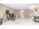 Open basement area with tile floors, staircase, bar seating, and adjacent room, creating a versatile space at 1970 E Yellowstone Pl, Chandler, AZ 85249