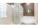 Modern bathroom featuring a glass block shower and a soaking tub at 1970 E Yellowstone Pl, Chandler, AZ 85249