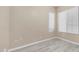 Empty bedroom with neutral walls, laminate floors, two windows and base trim, offering a blank canvas at 1970 E Yellowstone Pl, Chandler, AZ 85249