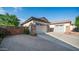 Long driveway leading to the garages, with a beautiful stone accent wall and desert landscaping at 1970 E Yellowstone Pl, Chandler, AZ 85249