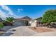 Charming single-story home featuring stone accents, a tile roof, and a spacious three-car garage at 1970 E Yellowstone Pl, Chandler, AZ 85249