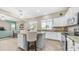 Well-lit kitchen with white cabinets, granite countertops, an island, and views into the backyard at 1970 E Yellowstone Pl, Chandler, AZ 85249