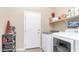 Well-organized laundry room featuring modern washer and dryer set with built-in shelving for storage at 1970 E Yellowstone Pl, Chandler, AZ 85249