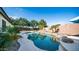 Backyard pool featuring rock waterfall and mature landscaping provides the perfect outdoor retreat at 1970 E Yellowstone Pl, Chandler, AZ 85249