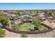 Aerial view of a home featuring solar panels, a large backyard, a covered patio, and lush landscaping in a Gathering-friendly community at 21188 N Duncan Dr, Maricopa, AZ 85138
