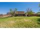 Extensive backyard with mature trees, covered patio, and ample space for outdoor recreation and enjoyment at 21188 N Duncan Dr, Maricopa, AZ 85138