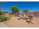 Spacious backyard features a fire pit and trampoline, creating a fun and inviting outdoor entertainment space at 21188 N Duncan Dr, Maricopa, AZ 85138