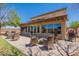 Relaxing outdoor patio with comfortable wicker furniture, fire pit, and backyard views, ideal for gatherings at 21188 N Duncan Dr, Maricopa, AZ 85138