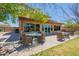 Inviting outdoor patio with wicker furniture, offering a serene view of the backyard and beautiful landscaping at 21188 N Duncan Dr, Maricopa, AZ 85138