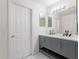Bathroom with a double vanity, marble countertop, decorative hardware and updated fixtures and white marble floors at 21188 N Duncan Dr, Maricopa, AZ 85138