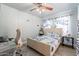 Bedroom with a bed, ocean themed decor, turtle curtains and a ceiling fan at 21188 N Duncan Dr, Maricopa, AZ 85138