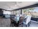 Open dining room with a large table, backyard view, and a comfortable living space at 21188 N Duncan Dr, Maricopa, AZ 85138