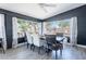 Bright dining room with large windows overlooking the backyard and a long table with chairs at 21188 N Duncan Dr, Maricopa, AZ 85138