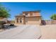 Charming two-story home with a spacious driveway and well-maintained desert landscaping at 21188 N Duncan Dr, Maricopa, AZ 85138