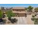 Charming two-story home with a spacious driveway and well-maintained desert landscaping at 21188 N Duncan Dr, Maricopa, AZ 85138