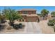 Charming two-story home with a spacious driveway and well-maintained desert landscaping at 21188 N Duncan Dr, Maricopa, AZ 85138