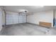 Empty garage with concrete floor and walls and closed door at 21188 N Duncan Dr, Maricopa, AZ 85138