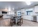 Bright, open kitchen with white cabinets, modern appliances, and a central island with seating at 21188 N Duncan Dr, Maricopa, AZ 85138