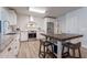 Bright, open kitchen with white cabinets, modern appliances, and a central island with seating at 21188 N Duncan Dr, Maricopa, AZ 85138