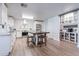 Bright, open kitchen with white cabinets, modern appliances, and a central island with seating at 21188 N Duncan Dr, Maricopa, AZ 85138