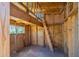 An interior view of a wooden playhouse, with a ladder leading to a loft area and a window showing glimpses of the outdoors at 21188 N Duncan Dr, Maricopa, AZ 85138