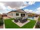 Spacious backyard with artificial turf, a refreshing pool, a firepit lounge, and a bocce ball court at 24035 N 171St Dr, Surprise, AZ 85387