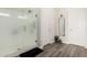 Beautiful bathroom with a stand-alone shower with glass doors and wood-look floors at 24035 N 171St Dr, Surprise, AZ 85387