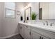 Bathroom featuring a double sink vanity with white countertops and modern fixtures at 24035 N 171St Dr, Surprise, AZ 85387