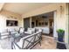 Relaxing covered patio with stylish furniture, outdoor décor, and seamless access to the indoor living space at 24035 N 171St Dr, Surprise, AZ 85387