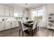 Well-lit dining room featuring a large table, modern chairs, and bright windows at 24035 N 171St Dr, Surprise, AZ 85387
