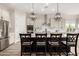 Bright kitchen features an island with chairs, stainless steel appliances, and white cabinetry at 24035 N 171St Dr, Surprise, AZ 85387