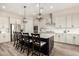 Bright kitchen features a large island with chairs, modern appliances, and white cabinetry at 24035 N 171St Dr, Surprise, AZ 85387
