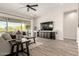 Bright living room featuring tile floors, modern furniture, and backyard views at 24035 N 171St Dr, Surprise, AZ 85387
