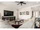 Cozy living room with a comfortable sectional sofa, dark wood furniture and stylish decor at 24035 N 171St Dr, Surprise, AZ 85387