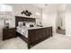 This main bedroom features a bed with wood trim, carpet floors, and lots of natural light at 24035 N 171St Dr, Surprise, AZ 85387