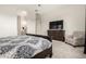 This main bedroom includes carpet floors, a view to the bathroom, and a stylish chair at 24035 N 171St Dr, Surprise, AZ 85387