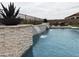 Backyard pool featuring a waterfall feature with decorative stone pillars and patio furniture at 24035 N 171St Dr, Surprise, AZ 85387