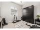 Gym or exercise room with treadmill, exercise bike, yoga mat and storage cabinet at 24035 N 171St Dr, Surprise, AZ 85387