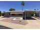 Charming single-story home with desert landscaping, awning-covered parking, and comfortable curb appeal at 2405 N Eastwood Way, Mesa, AZ 85215